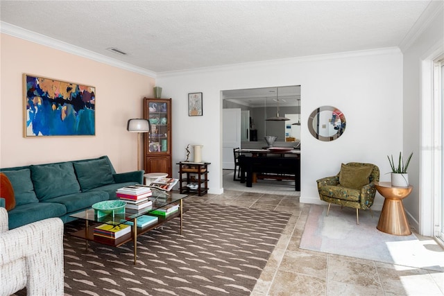 living room featuring visible vents, a textured ceiling, and ornamental molding