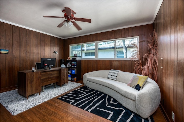 office with crown molding, ceiling fan, wooden walls, and wood finished floors