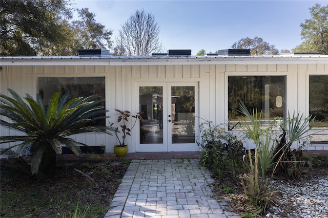 view of exterior entry with metal roof and french doors