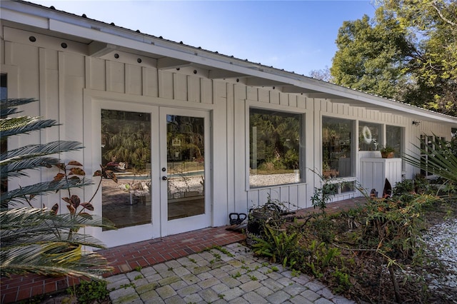 property entrance featuring french doors and board and batten siding