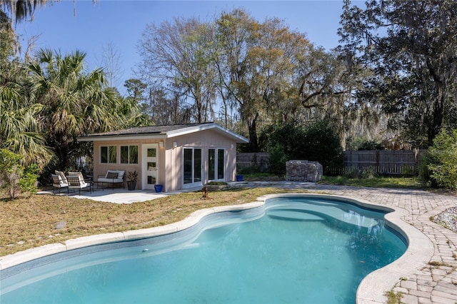 view of swimming pool with a fenced in pool, a patio, an outbuilding, a storage structure, and fence