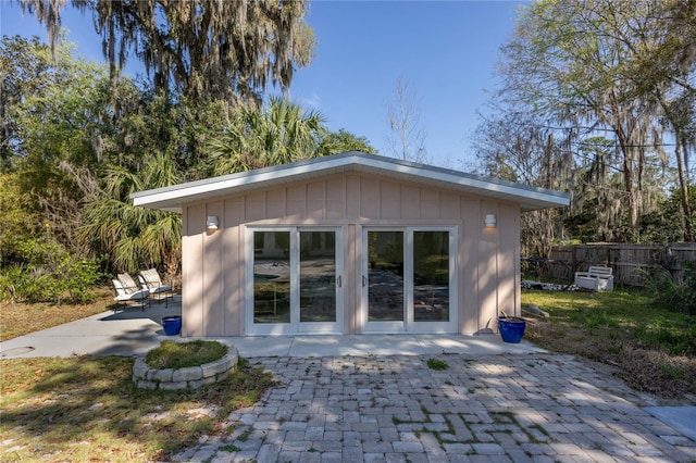 view of outbuilding featuring fence and an outdoor structure