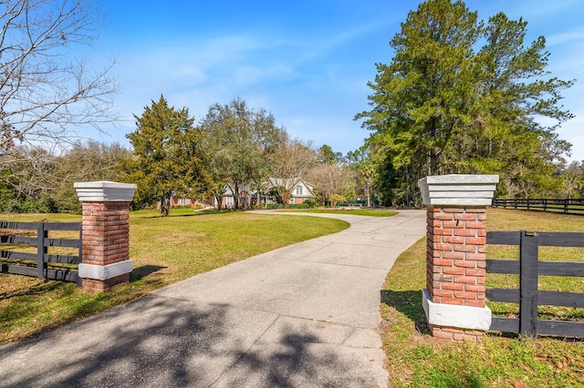 exterior space featuring a lawn and fence