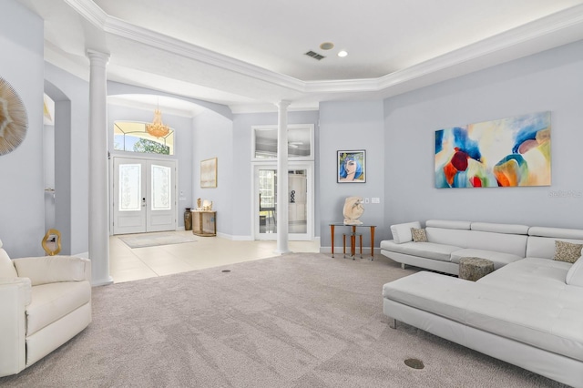 living area featuring visible vents, carpet floors, french doors, and decorative columns