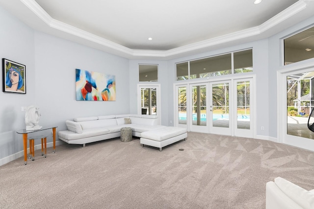 interior space featuring baseboards, french doors, a tray ceiling, crown molding, and carpet flooring