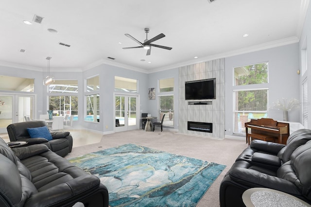 living room with french doors, a fireplace, a wealth of natural light, visible vents, and carpet flooring