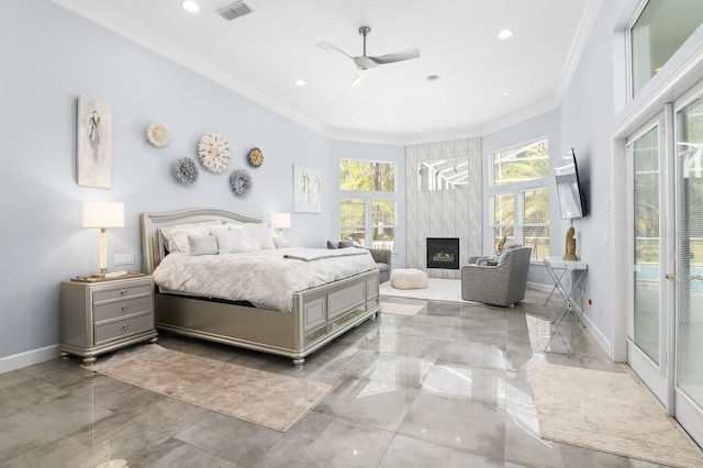 bedroom with baseboards, a tiled fireplace, visible vents, and crown molding