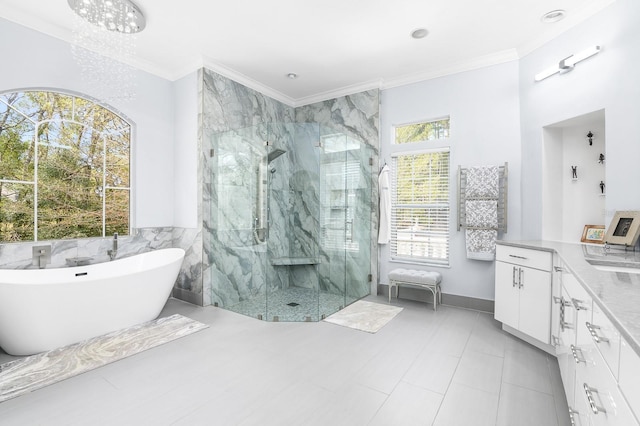 full bathroom with ornamental molding, a freestanding tub, a marble finish shower, and vanity