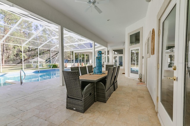 view of patio featuring a lanai, an outdoor pool, and a ceiling fan