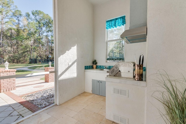 view of patio featuring exterior kitchen and visible vents