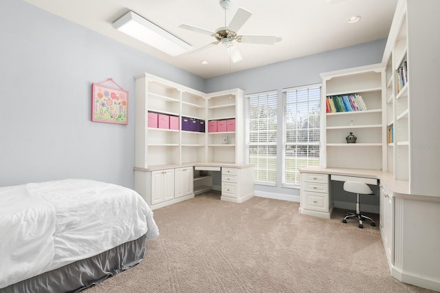 bedroom featuring baseboards, a ceiling fan, light colored carpet, built in desk, and recessed lighting