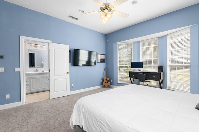 carpeted bedroom with a sink, a ceiling fan, baseboards, and connected bathroom