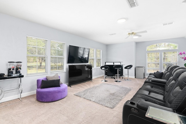 living room featuring carpet flooring, visible vents, and baseboards