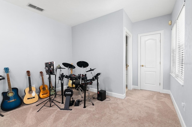 workout area with carpet, visible vents, and baseboards