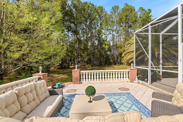 view of patio with glass enclosure and an outdoor living space