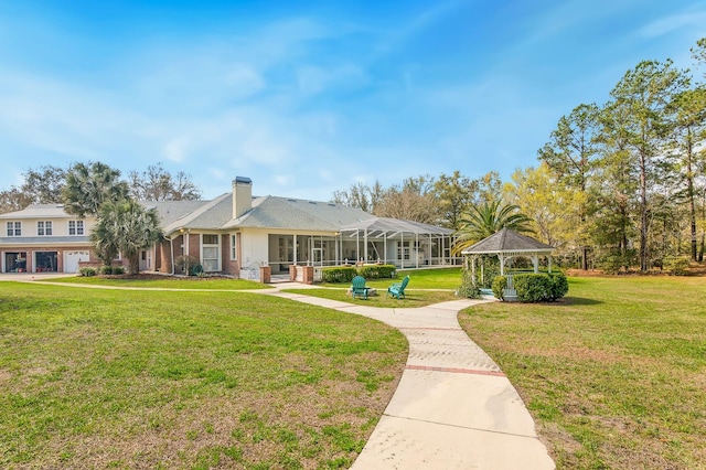 view of property's community with a lawn and a gazebo