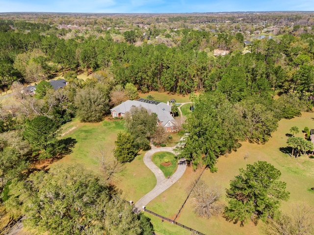 birds eye view of property with a view of trees