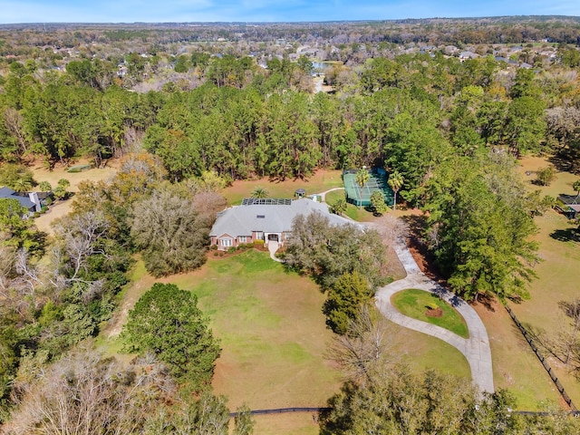 drone / aerial view featuring a wooded view