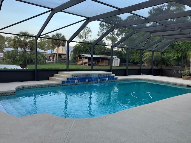 outdoor pool featuring a yard, a lanai, an outdoor structure, and a storage shed