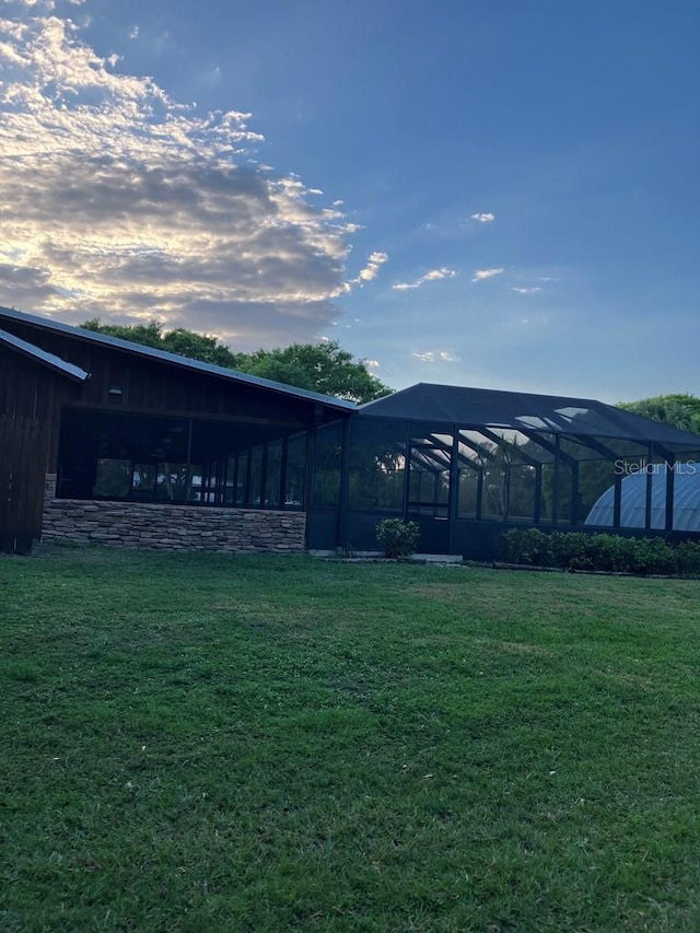 view of yard with glass enclosure