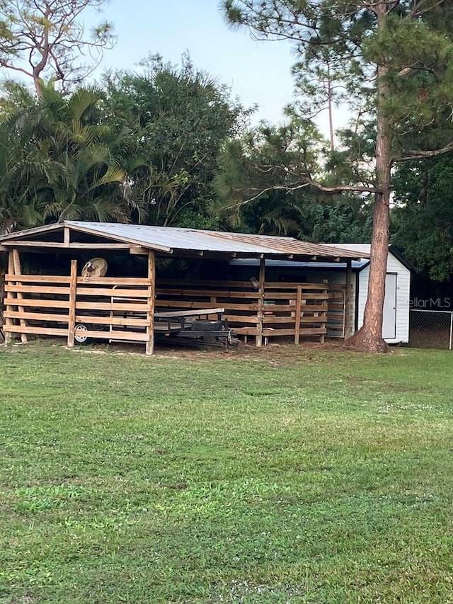 view of yard featuring fence and an outdoor structure