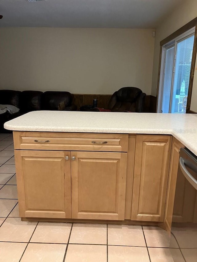 kitchen featuring light countertops, dishwasher, visible vents, and light tile patterned floors