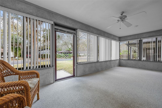 sunroom featuring ceiling fan