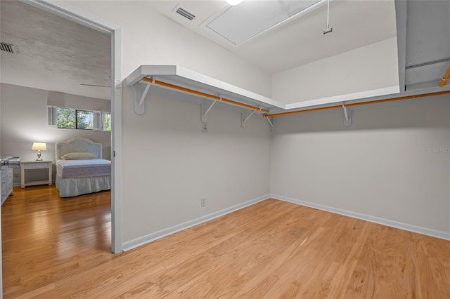 spacious closet with light wood finished floors and visible vents