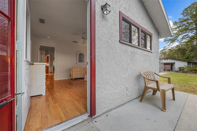 doorway to property with visible vents and stucco siding