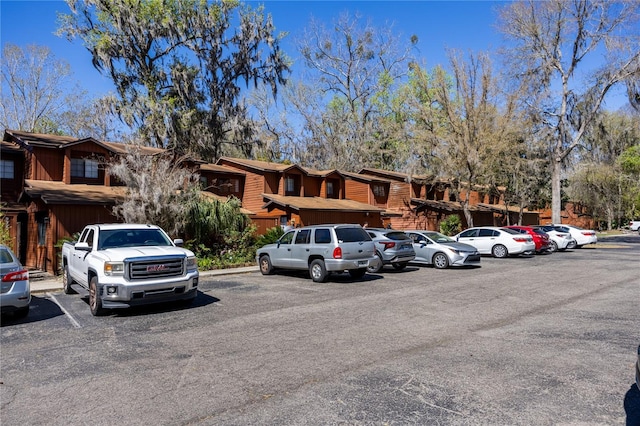 uncovered parking lot featuring a residential view