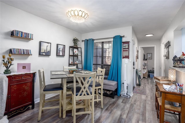 dining area with wood finished floors and baseboards