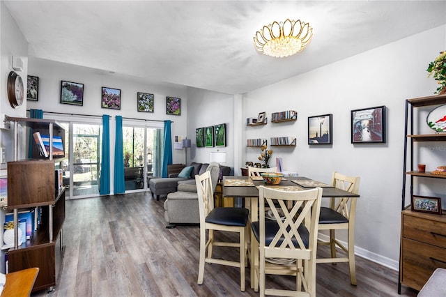 dining room featuring baseboards and wood finished floors