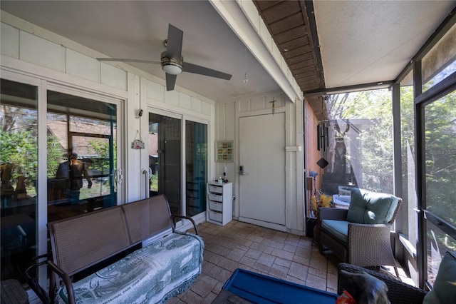 sunroom / solarium featuring a ceiling fan