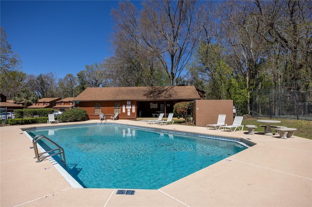 community pool featuring a patio area and fence