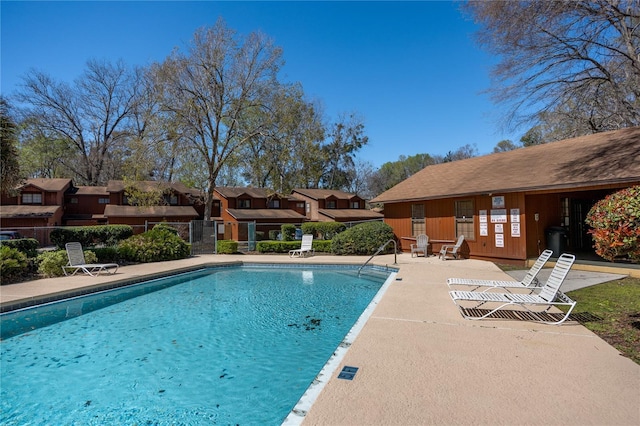 pool featuring fence and a patio