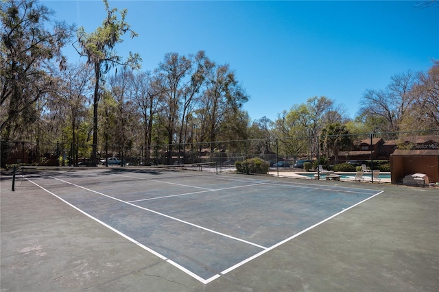 view of tennis court with fence