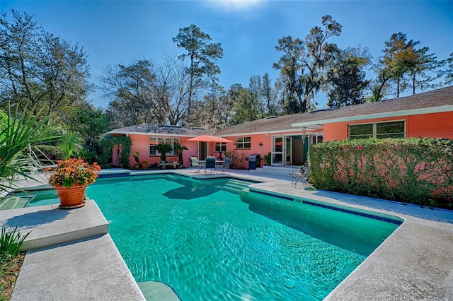 pool featuring a patio and grilling area