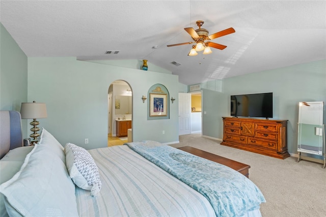 bedroom with arched walkways, light carpet, lofted ceiling, and visible vents