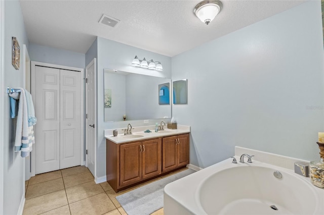 full bath with a garden tub, visible vents, a sink, and tile patterned floors