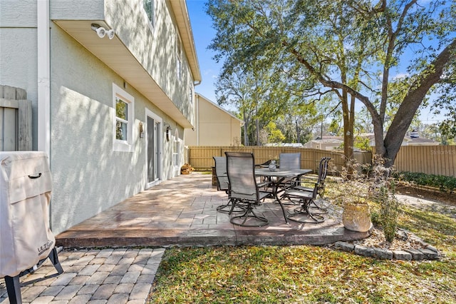 view of patio / terrace with outdoor dining area, grilling area, and a fenced backyard