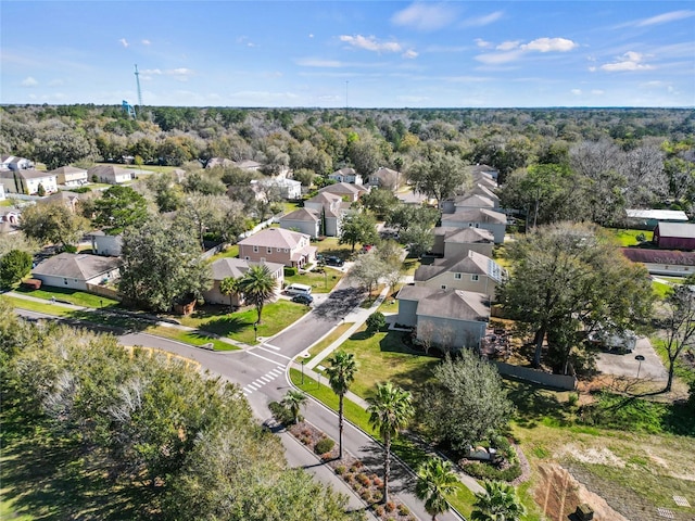 drone / aerial view featuring a residential view and a forest view