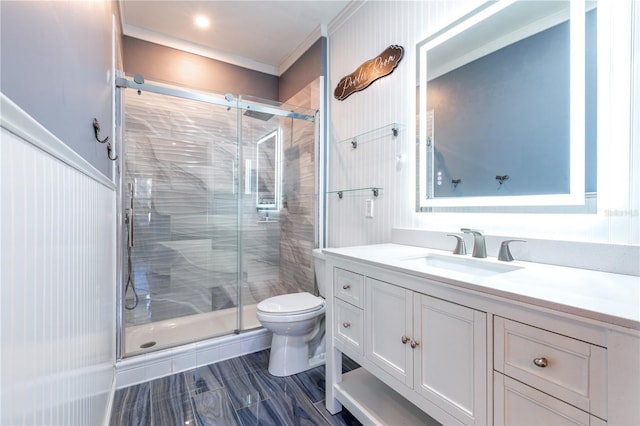 bathroom with vanity, ornamental molding, a shower stall, and toilet