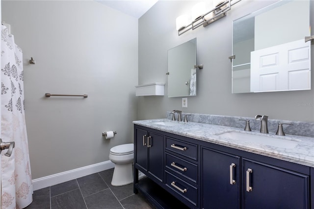 bathroom with baseboards, a sink, toilet, and tile patterned floors