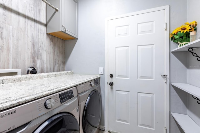 washroom with separate washer and dryer and cabinet space