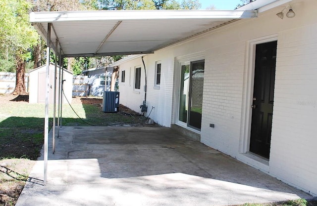 view of patio with an outbuilding, a storage shed, and central AC unit