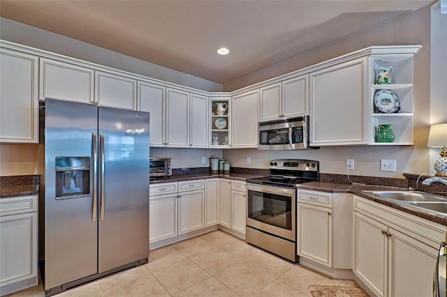 kitchen with light tile patterned floors, stainless steel appliances, open shelves, a sink, and recessed lighting