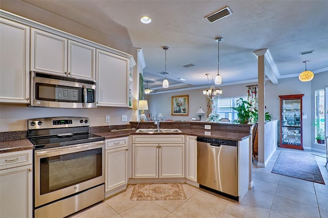 kitchen with crown molding, light tile patterned floors, stainless steel appliances, visible vents, and a sink