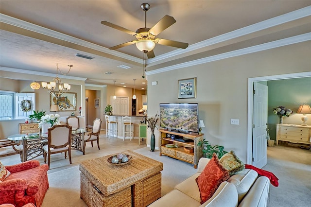 living area featuring ceiling fan with notable chandelier, ornamental molding, visible vents, and light colored carpet