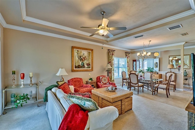 living room featuring light carpet, ceiling fan with notable chandelier, a raised ceiling, and crown molding