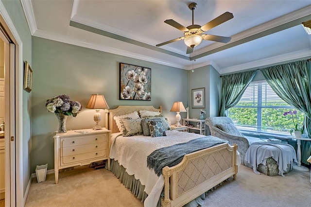 carpeted bedroom featuring ornamental molding, a tray ceiling, ceiling fan, and baseboards